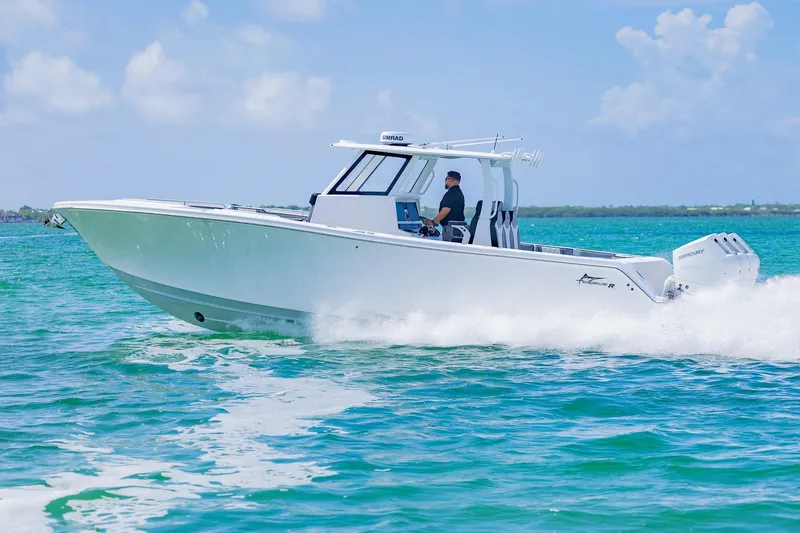 Slide: The Image of 2025 Streamline R 35 boat cruising on clear blue water under a sunny sky. - 8