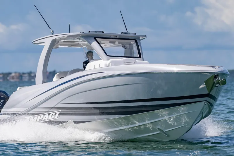 Slide: The Image of 2024 Deep Impact 399 Sport boat cruising on open water, showcasing sleek design and performance. - 12