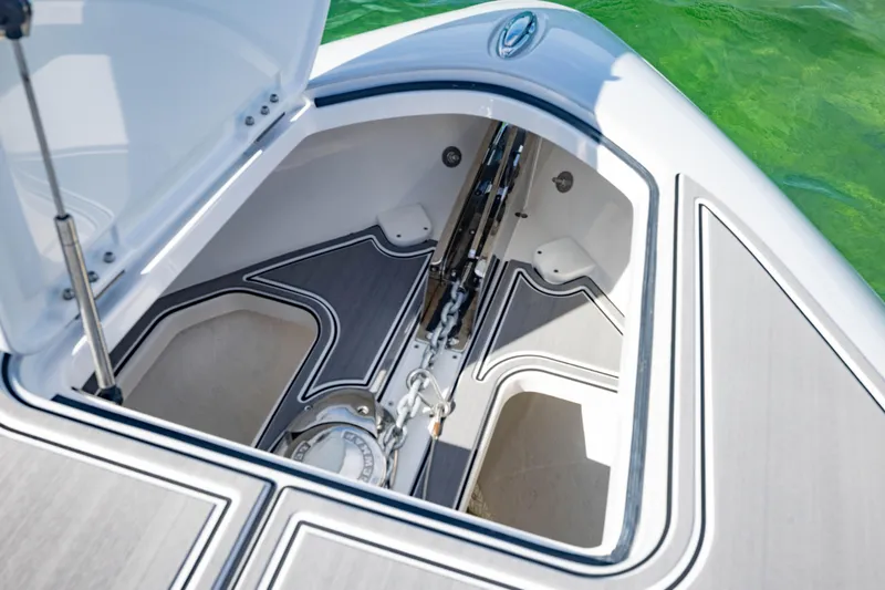 Slide: The Image of Open anchor compartment of 2024 Deep Impact 399 Sport boat, showcasing storage and design. - 25