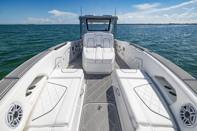 Slide: The Image of 2024 Deep Impact 399 Sport boat interior with luxurious seating on open water. - 26
