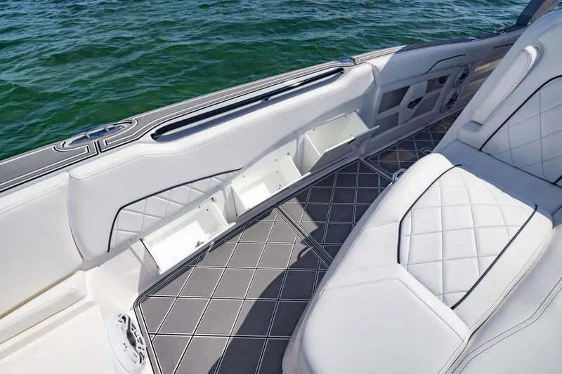 Slide: The Image of Luxurious interior of 2024 Deep Impact 399 Sport boat with white seating and storage compartments. - 28