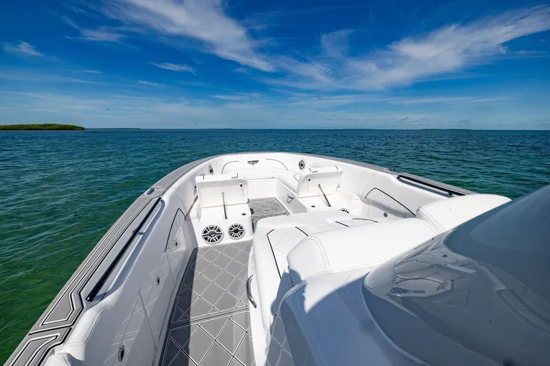 Slide: The Image of 2024 Deep Impact 399 Sport boat on open water under clear blue sky. - 30