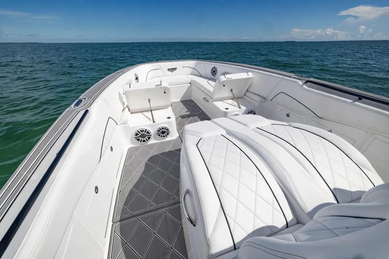 Slide: The Image of 2024 Deep Impact 399 Sport boat interior with luxurious white seating on open water. - 32