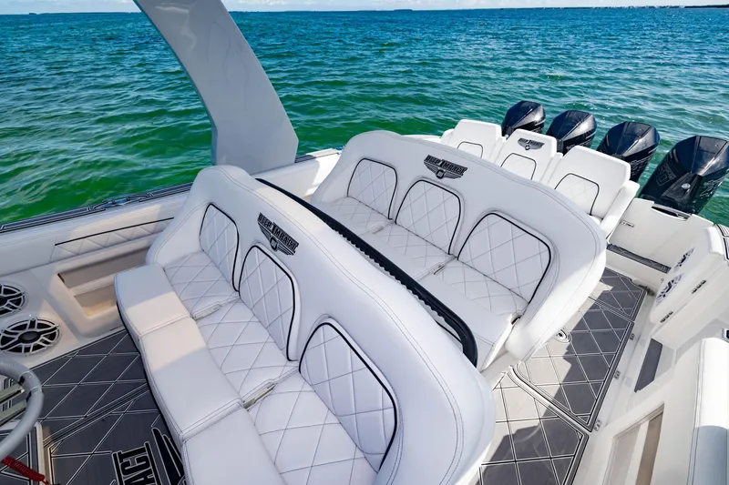 Slide: The Image of 2024 Deep Impact 399 Sport boat interior with luxurious white seating and ocean backdrop. - 36