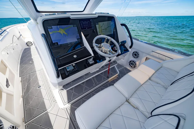 Slide: The Image of 2024 Deep Impact 399 Sport boat interior with advanced navigation system and luxurious seating. - 37