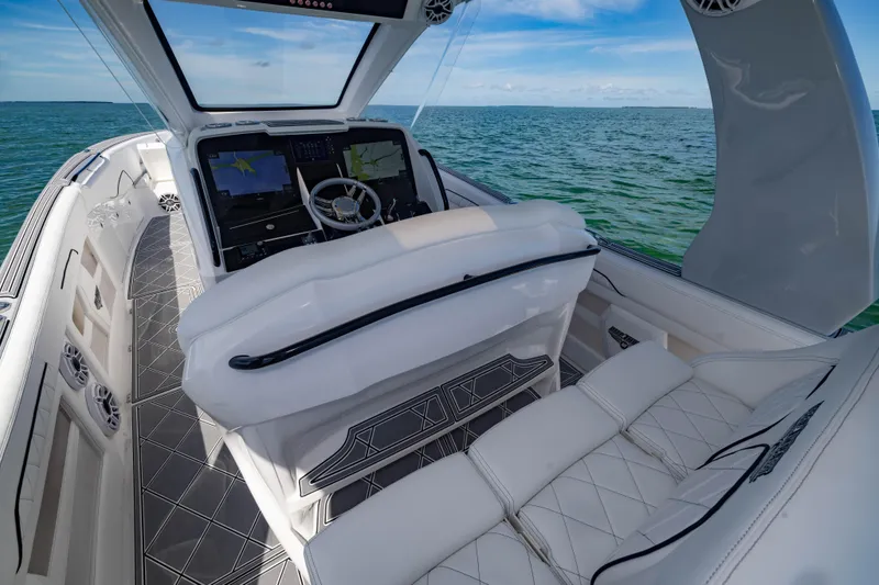 Slide: The Image of 2024 Deep Impact 399 Sport boat interior with luxurious seating and advanced navigation system. - 38