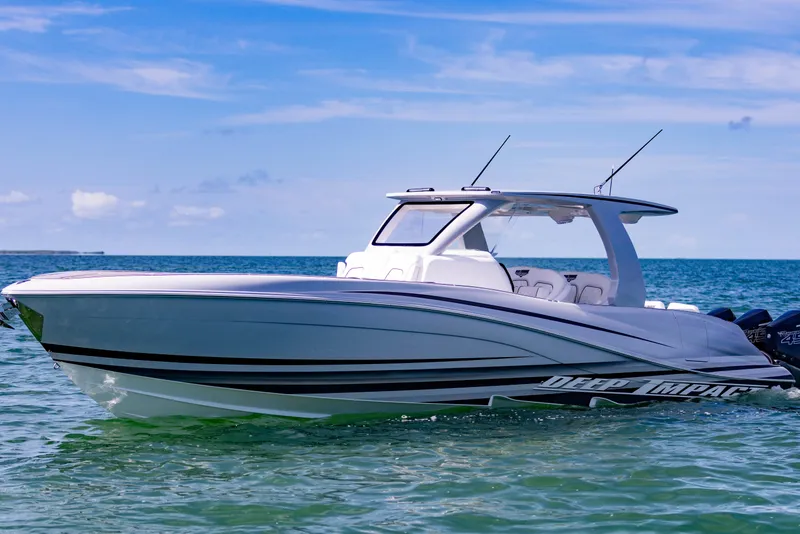 Slide: The Image of 2024 Deep Impact 399 Sport boat on calm ocean waters under clear blue sky. - 4