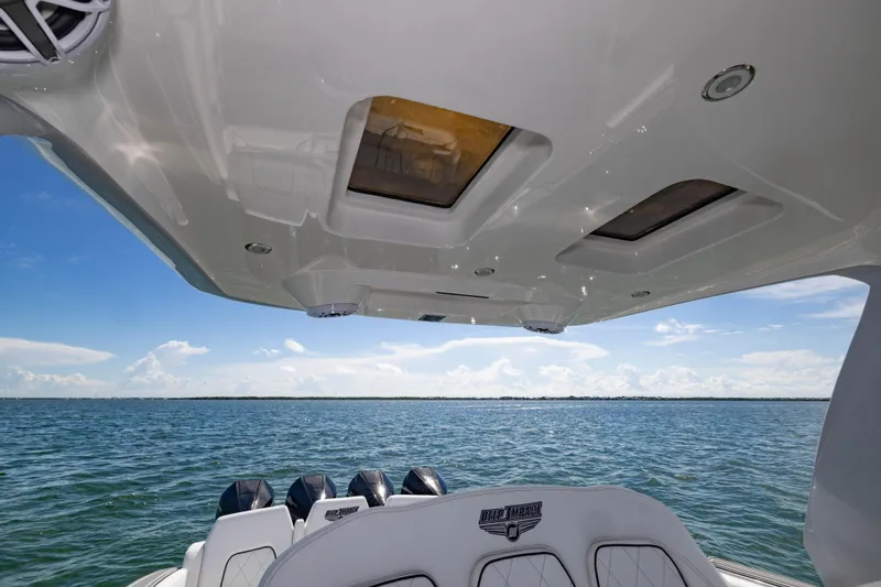 Slide: The Image of 2024 Deep Impact 399 Sport boat interior with ocean view and clear sky. - 43