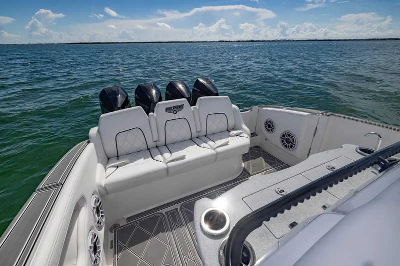Slide: The Image of 2024 Deep Impact 399 Sport boat interior with luxurious seating and ocean view. - 44