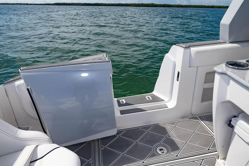 Slide: The Image of 2024 Deep Impact 399 Sport boat interior with open door, overlooking serene water. - 47