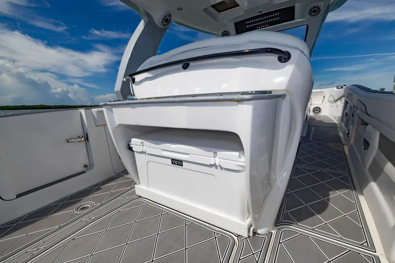 Slide: The Image of 2024 Deep Impact 399 Sport boat interior with Yeti cooler and sleek design. - 48