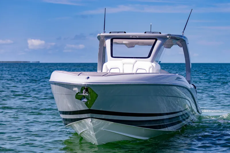 Slide: The Image of 2024 Deep Impact 399 Sport boat on clear blue water, front view. - 5