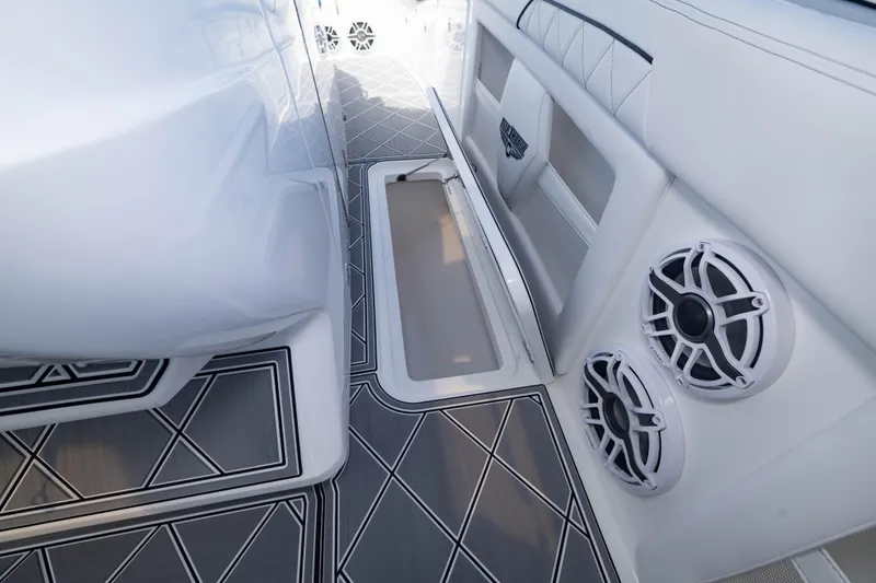 Slide: The Image of 2024 Deep Impact 399 Sport boat interior with sleek design, speakers, and storage compartment. - 51