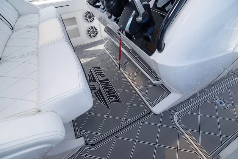 Slide: The Image of 2024 Deep Impact 399 Sport boat interior with white seating and custom flooring. - 52