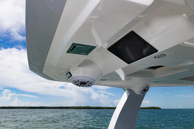 Slide: The Image of 2024 Deep Impact 399 Sport boat with advanced electronics and speakers, cruising on a sunny day. - 55