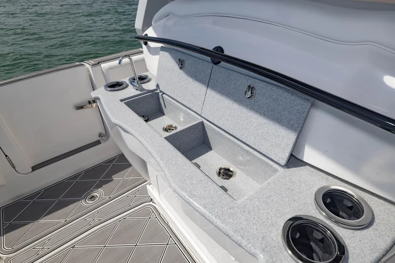 Slide: The Image of 2024 Deep Impact 399 Sport boat interior with sink and storage compartments. - 56