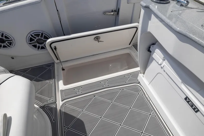Slide: The Image of 2024 Deep Impact 399 Sport boat interior with storage compartment and Yeti cooler. - 57