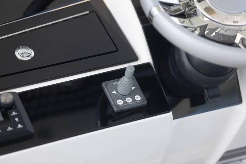 Slide: The Image of 2024 Deep Impact 399 Sport boat dashboard with joystick control and steering wheel. - 63