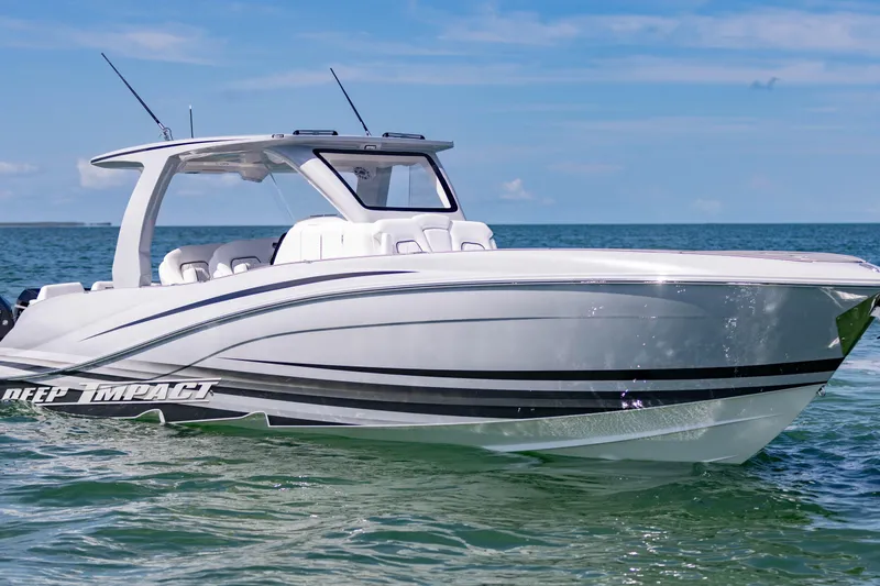 Slide: The Image of 2024 Deep Impact 399 Sport boat on calm ocean waters under clear blue sky. - 7