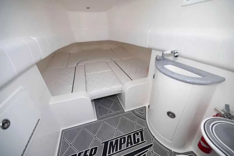 Slide: The Image of 2024 Deep Impact 399 Sport cabin interior with cushioned seating and compact sink area. - 70