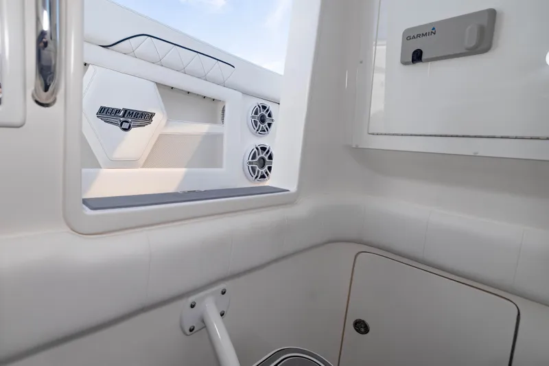 Slide: The Image of 2024 Deep Impact 399 Sport boat interior with speakers and Garmin equipment. - 73