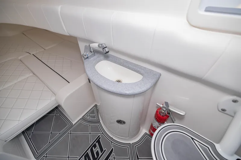 Slide: The Image of 2024 Deep Impact 399 Sport interior with sink, fire extinguisher, and cushioned seating. - 74