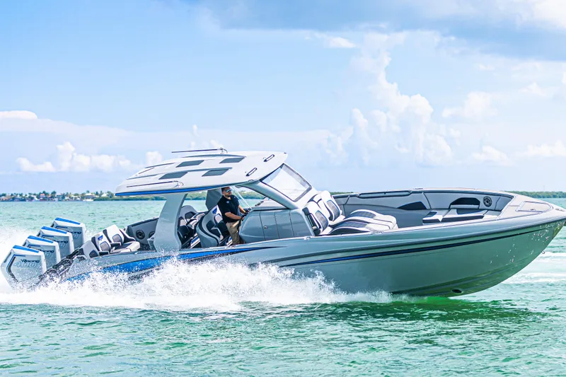 The Image of 2023 Deep Impact 399 Sport boat cruising on clear blue water. - 1