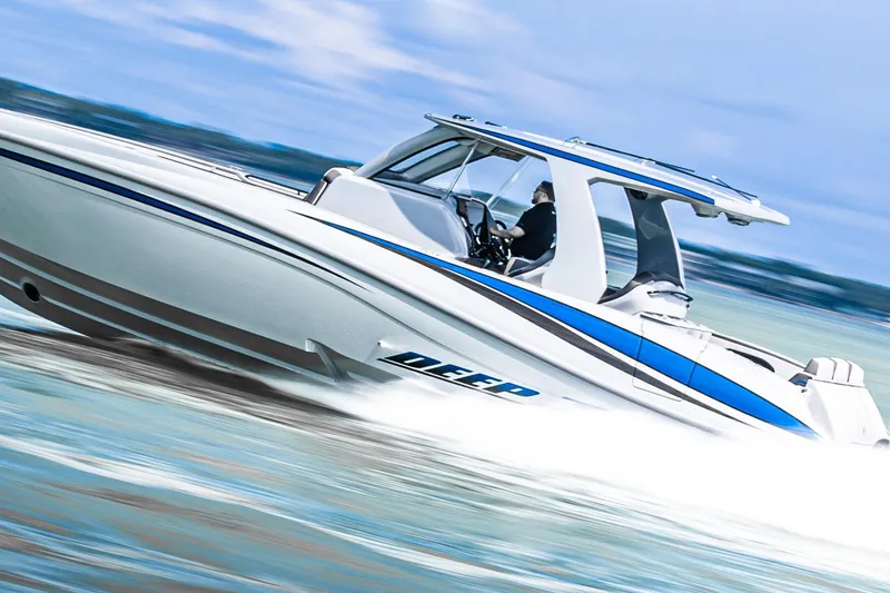 Slide: The Image of 2023 Deep Impact 399 Sport boat speeding on water, showcasing sleek design and performance. - 10