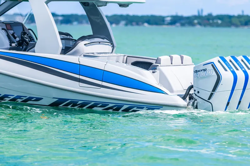 Slide: The Image of 2023 Deep Impact 399 Sport boat with powerful outboard engines on turquoise water. - 11