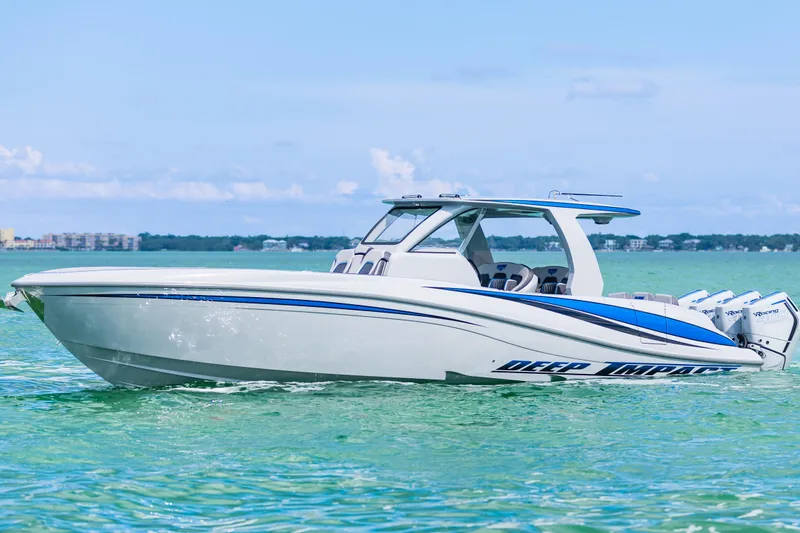 Slide: The Image of 2023 Deep Impact 399 Sport boat on clear turquoise water. - 12