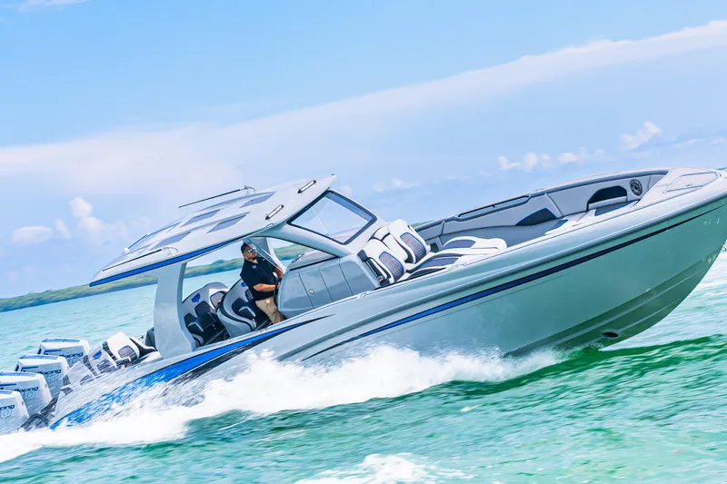 Slide: The Image of 2023 Deep Impact 399 Sport boat cruising on clear blue water. - 20