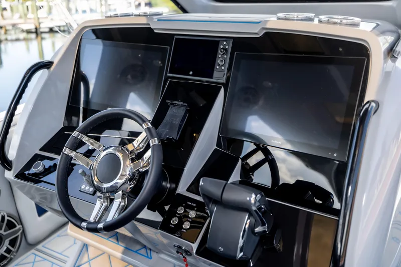 Slide: The Image of 2023 Deep Impact 399 Sport boat dashboard with modern steering and digital displays. - 22