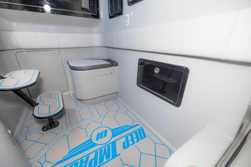 Slide: The Image of 2023 Deep Impact 399 Sport interior with modern seating and sleek design. - 25