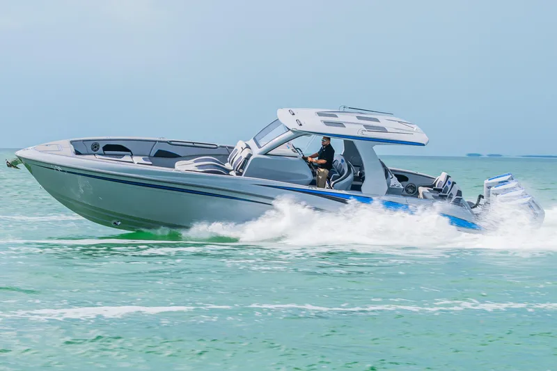Slide: The Image of 2023 Deep Impact 399 Sport boat cruising on open water. - 3
