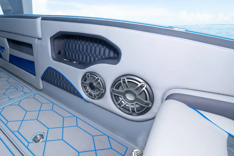 Slide: The Image of Interior of 2023 Deep Impact 399 Sport boat with stylish speakers and blue accents. - 38