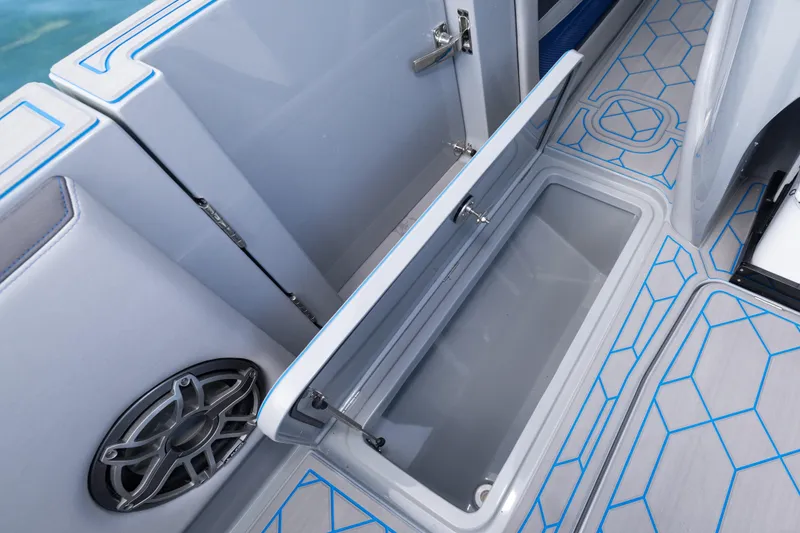 Slide: The Image of 2023 Deep Impact 399 Sport boat interior storage compartment with modern design and speaker. - 43