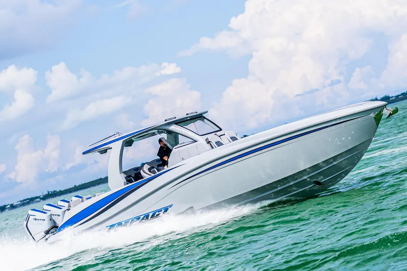 Slide: The Image of 2023 Deep Impact 399 Sport boat cruising on open water under a clear sky. - 5