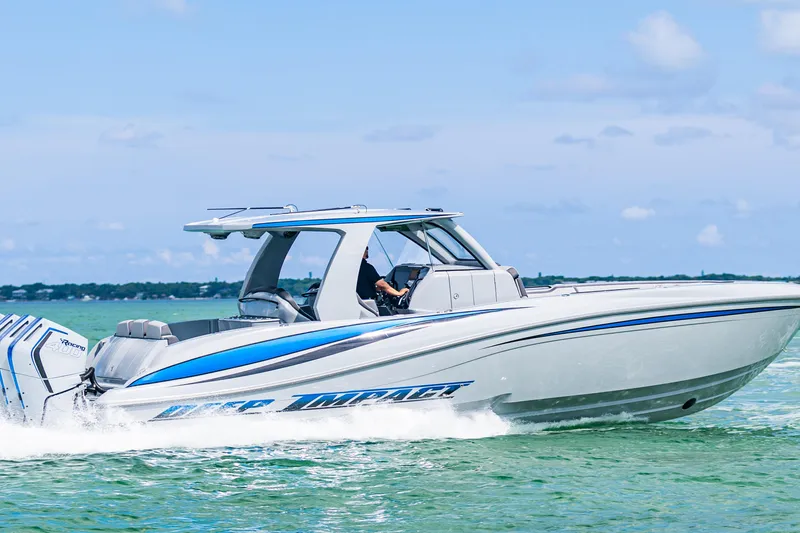 Slide: The Image of 2023 Deep Impact 399 Sport boat cruising on clear blue water. - 6