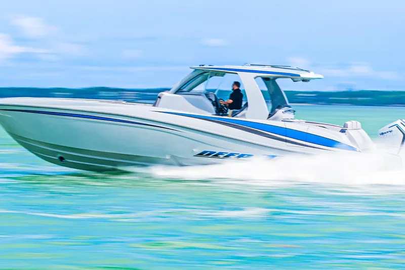 Slide: The Image of 2023 Deep Impact 399 Sport boat speeding on turquoise water. - 7