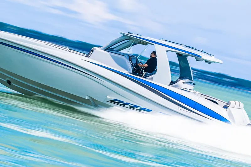 Slide: The Image of 2023 Deep Impact 399 Sport boat speeding on water, showcasing sleek design and performance. - 8