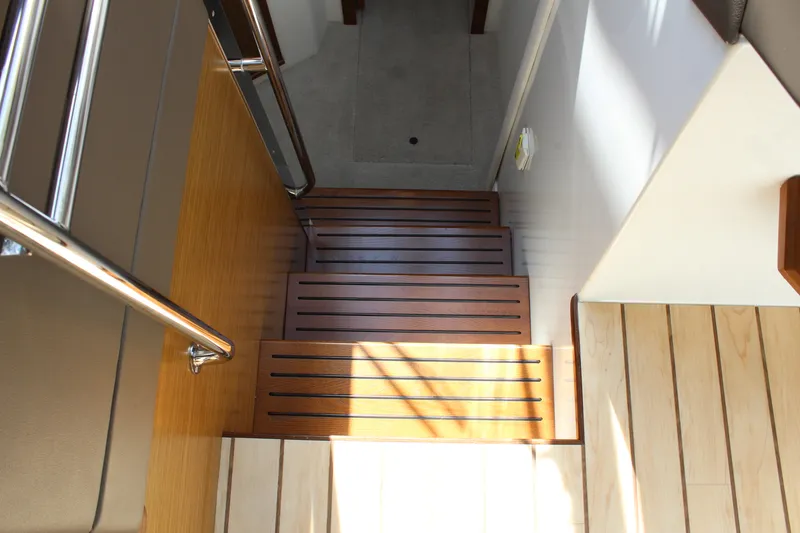 Slide: The Image of Wooden stairs inside the 2014 Cruisers Yachts 45 Cantius. - 33