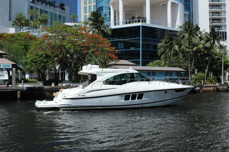 Slide: The Image of 2014 Cruisers Yachts 45 Cantius on a river with modern buildings. - 1