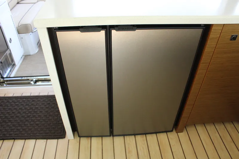 Slide: The Image of 2014 Cruisers Yachts 45 Cantius kitchen area with refrigerator. - 20