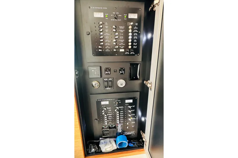 Slide: The Image of Electrical panel inside 2014 Cruisers Yachts 45 Cantius, showcasing switches and controls. - 73