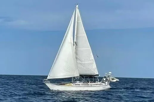 Slide: The Image of 1986 Gulfstar Hirsch 45 sailboat on stands in a marina setting. - 2