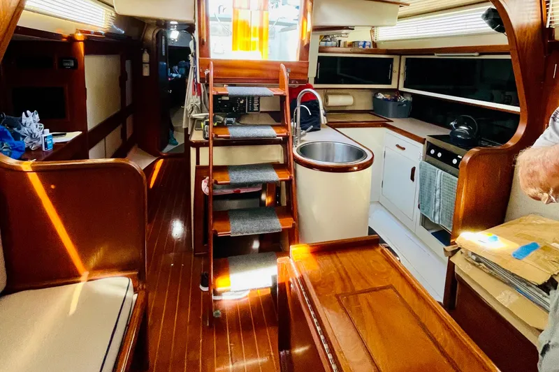 Slide: The Image of Interior of 1986 Gulfstar Hirsch 45 yacht with wooden stairs and compact kitchen. - 38