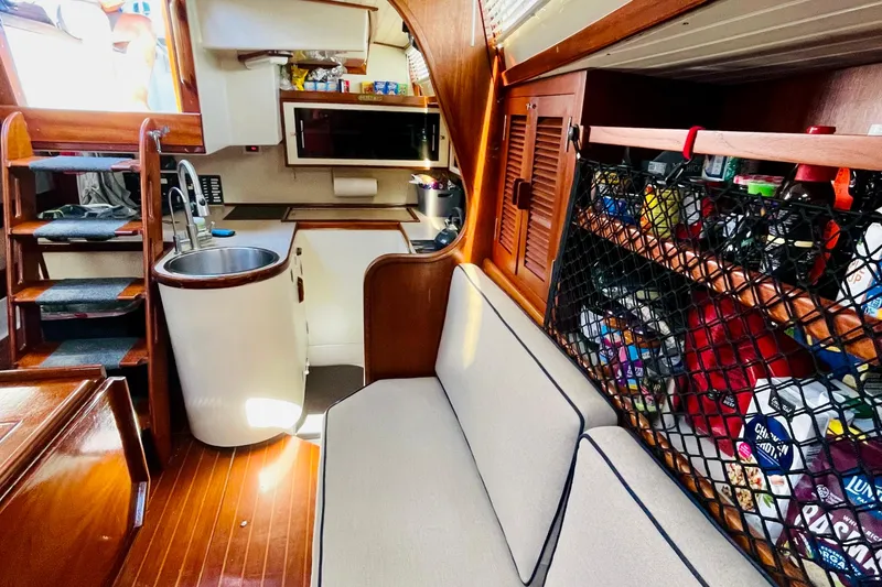Slide: The Image of 1986 Gulfstar Hirsch 45 yacht interior with compact kitchen, sink, stove, and wooden cabinetry. - 39