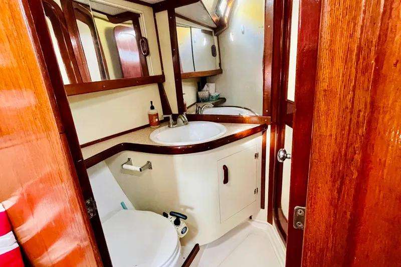 Slide: The Image of 1986 Gulfstar Hirsch 45 yacht bathroom with sink, mirror, and toilet. - 49