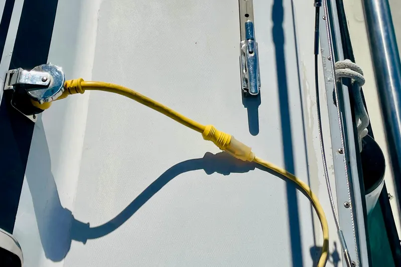 Slide: The Image of Yellow power cable on 1986 Gulfstar HIRSCH boat deck, connected to a metal socket. - 10