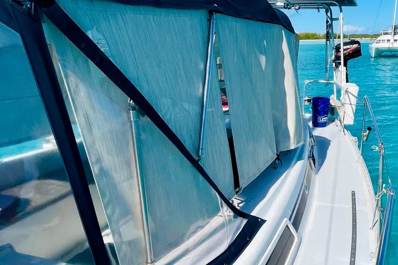 Slide: The Image of 1986 Gulfstar HIRSCH sailboat with canopy, docked in clear blue water. - 17